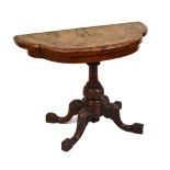 A Victorian walnut and burr walnut card table of shaped outline on turned column to four outswept