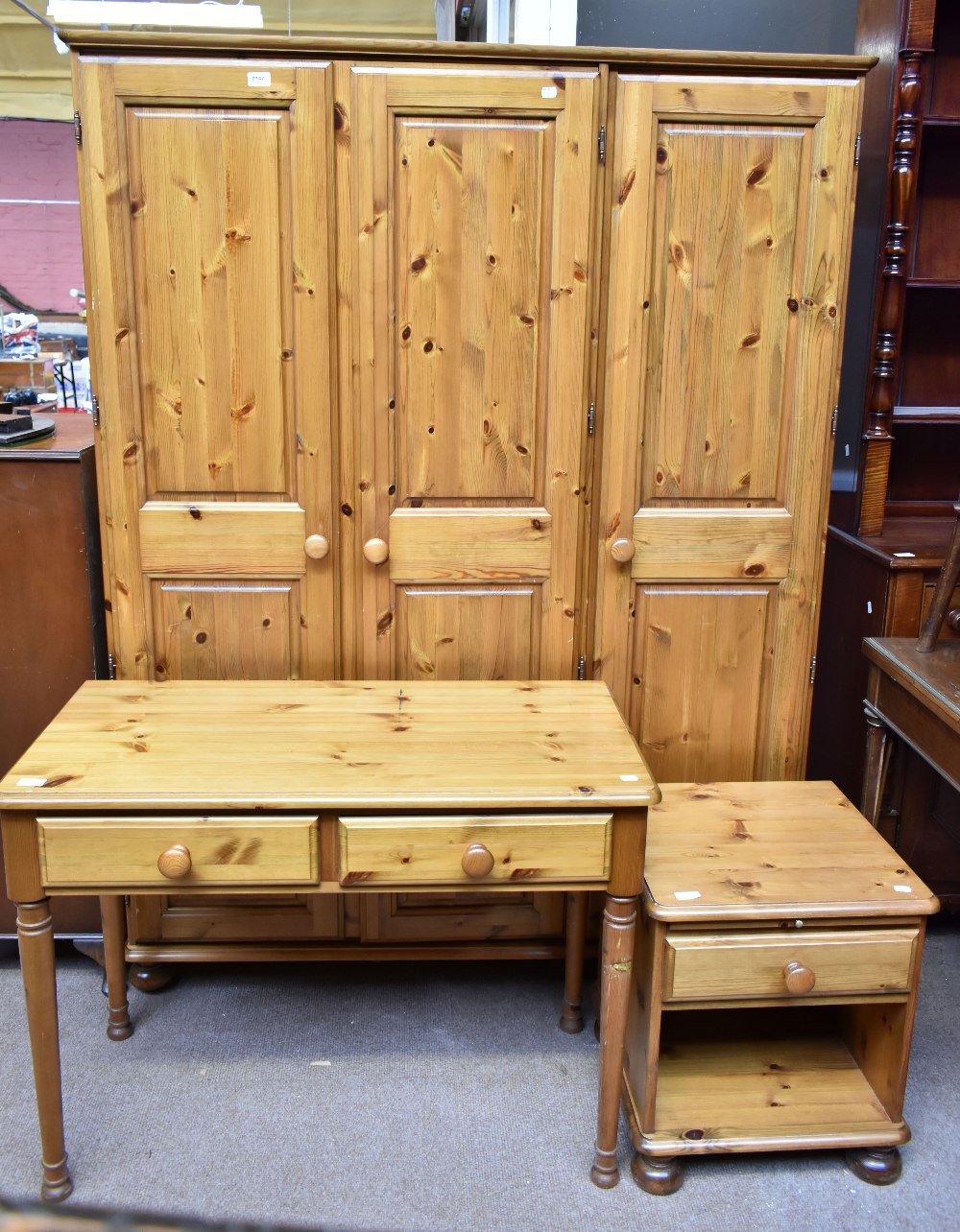 A modern pine triple wardrobe, dressing table and bedside cupboard (3).