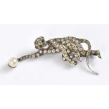 WITHDRAWN A novelty white metal diamond and pearl brooch modelled as a climbing monkey, with