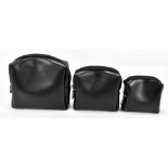 FURLA; three black leather cases, the largest is 15 x 15cm with a zip top and embossed Furla logo (
