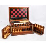 An early 20th century mahogany cased games compendium with gilt tooled leather chess board, an