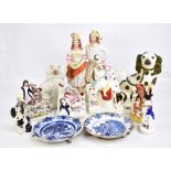 A collection of Staffordshire figures, two Delft plates and a group of 19th century and later blue