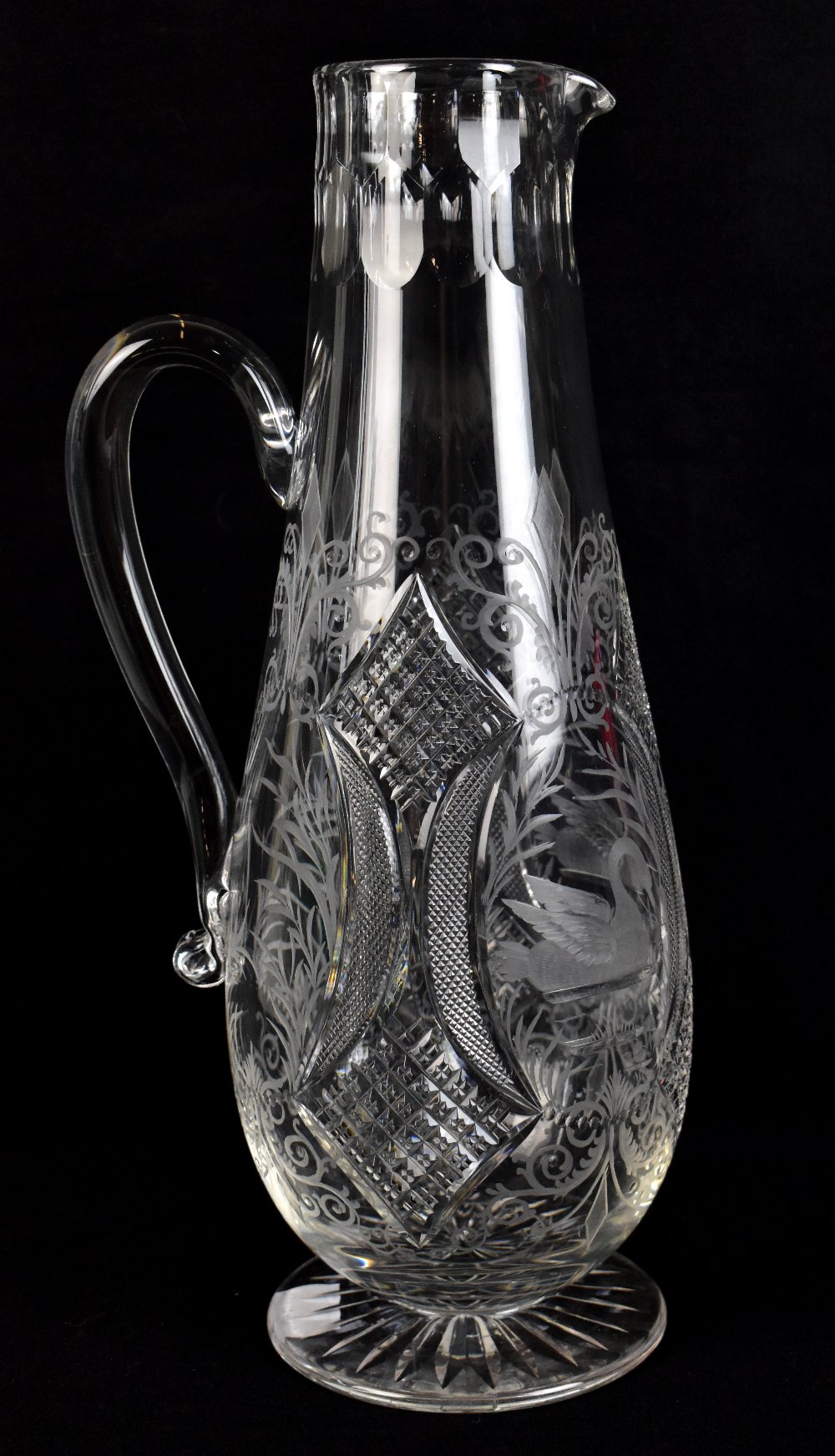 A good quantity early 20th century cut glass jug with engraved detail of swans and with simple