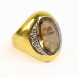 A yellow metal citrine and diamond dress ring, the inner band stamped 750, approx 8g, size J.