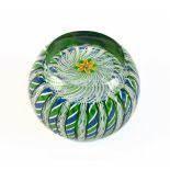 PERTHSHIRE; a glass paperweight encased with latticino and with central flower, unmarked, diameter