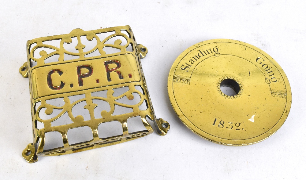 STEAM INTEREST; a brass standing/going register dated 1832, diameter 14.5cm and a C.P.R (Canadian
