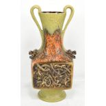 ATTRIBUTED TO DUMLER & BREIDEN; a West German eruption pottery twin handled vase with twin grotesque
