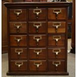 A mahogany library cabinet with an arrangement of fifteen drawers, with label to drawer inscribed '