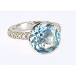 An 18ct white gold blue topaz and diamond ring, the raised collet set topaz weighing approx 5cts
