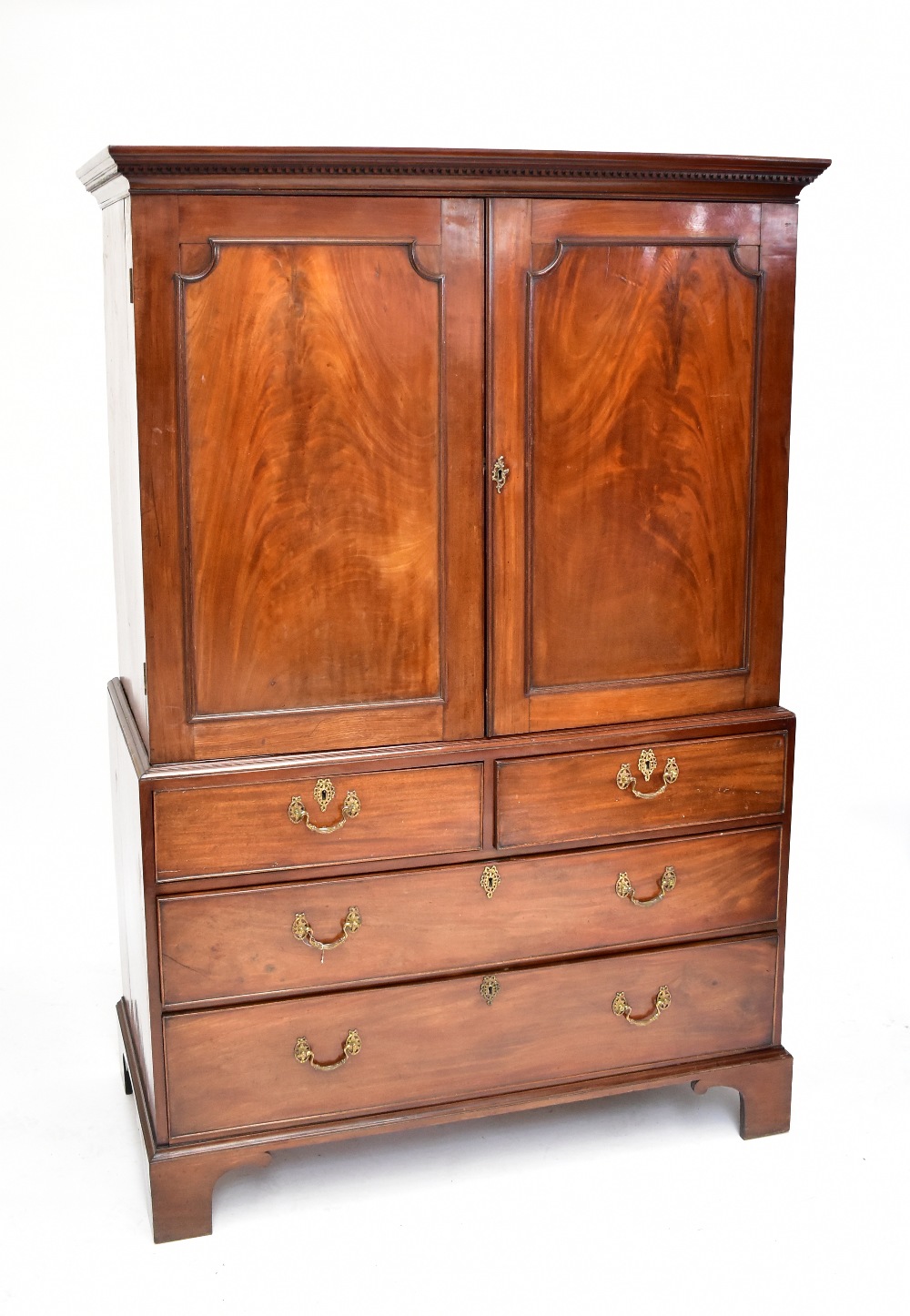 A George III mahogany linen press, the top section with two panelled doors enclosing two drawers