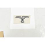A German Third Reich SS sport cloth badge with silver bullion work eagle and swastika device, with