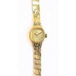 A lady's 9ct yellow gold wristwatch, the dial set with baton numerals, approx 10.3g.Additional