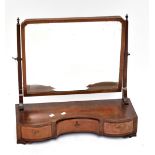 An Edwardian mahogany and inlaid swing toilet mirror, the base with shaped outline of three drawers,
