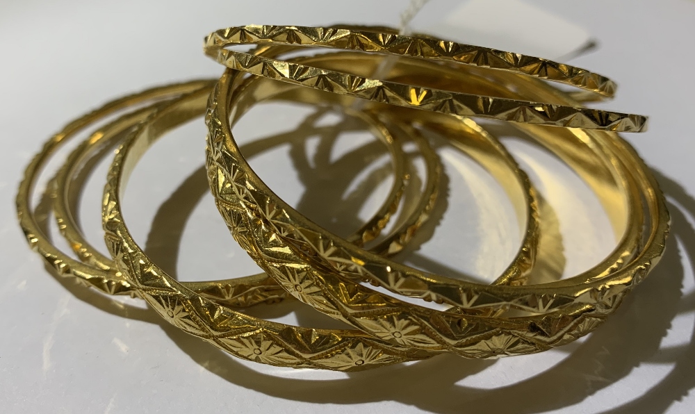 **AMENDED DESCRIPTION** Eight yellow metal bangles, six x 2mm diameter and two x 5mm diameter, total