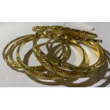 **AMENDED DESCRIPTION** Eight yellow metal bangles, six x 2mm diameter and two x 5mm diameter, total