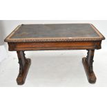 A Victorian carved oak library table. Additional InformationLifting to one corner of the leather,