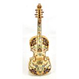 MOSANIC; a 19th century faience model of a violin with integral stand to the reverse, signed and