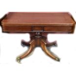 A William IV mahogany breakfast table with folding swivel top on turned column to quadripartite base