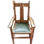 LIBERTY & CO; an Arts and Crafts oak open sided arm chair with carved splat back.