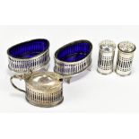 STOKES & IRELAND LTD; a George V hallmarked silver five piece cruet set, each with pierced