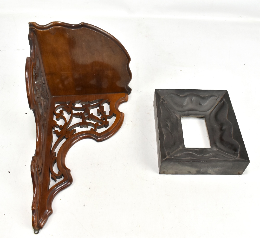 A deeply carved rectangular picture frame, 22 x 19cm, and a walnut corner wall bracket (2).