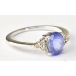 A 9ct white gold dress ring set with oval cut tanzanite and white stone chips, size K, approx 1.8g.