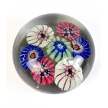 ATTRIBUTED TO ST MANDE; a clear glass paperweight with scattered canes, unmarked, diameter 5cm.