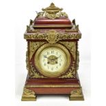 A large late 19th/early 20th century mantel clock with gilt metal foliate and cherubic mounts, the
