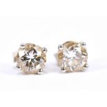 A pair of platinum and diamond ear studs, each round brilliant cut stone weighing 0.54cts, and