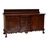 A large Continental bowfronted mahogany sideboard, with fretwork gallery above twin cupboard doors