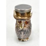 A novelty white metal vesta case modelled in the form of an owl wearing a top hat, with garnet eyes,