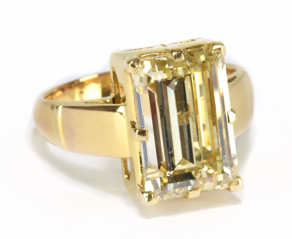 A good yellow metal diamond solitaire ring, the emerald cut stone weighing approx 7.3cts, in high