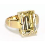 A good yellow metal diamond solitaire ring, the emerald cut stone weighing approx 7.3cts, in high