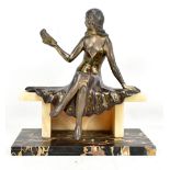 An Art Deco silvered spelter model of a girl on marble bench plinth holding a bird in one hand,