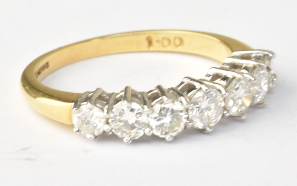 An 18ct yellow gold seven stone graduated diamond ring, diamond weight totalling 1ct, size N 1/2,