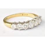 An 18ct yellow gold seven stone graduated diamond ring, diamond weight totalling 1ct, size N 1/2,