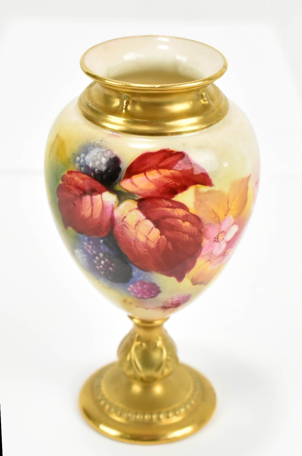 KITTY BLAKE FOR ROYAL WORCESTER; a hand painted pedestal vase, painted with fruits and flowers,