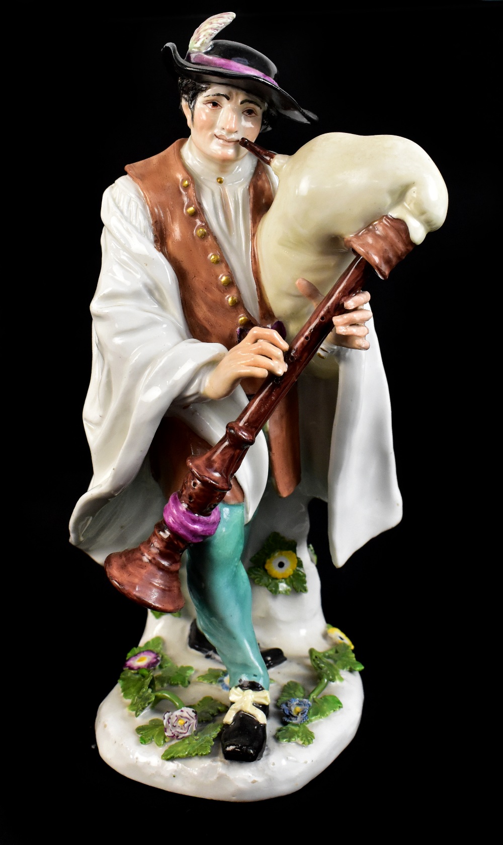 MEISSEN; a large mid-18th century figure of Piedmontese Bagpiper, modelled by Kaendler from the