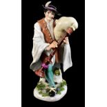 MEISSEN; a large mid-18th century figure of Piedmontese Bagpiper, modelled by Kaendler from the