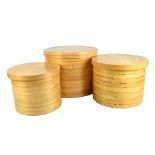 A set of three stacking cylindrical straw work boxes, diameter of largest 46cm.Additional