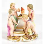 MEISSEN; a small porcelain figure group of four putti surrounding a fire, blue painted crossed