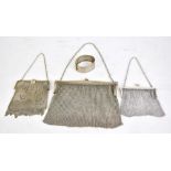 A George V hallmarked silver mounted mesh link purse, Birmingham 1922, two further purses with