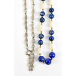A white metal fancy link necklace, stamped 900 to clasp, length 52cm, and a lapis lazuli and baroque
