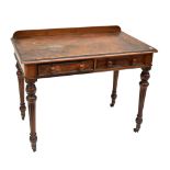 A Victorian walnut writing table, with two frieze drawers on turned legs to castors (for