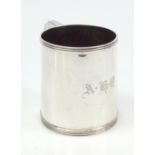 OLDFIELD LTD; a George V hallmarked silver mug with reeded detail and C-scroll handle, initialled '