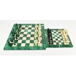 Two modern hardstone chess boards and two sets of playing pieces, one hardstone and one part bone.