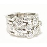 An 18ct white gold and diamond set six section ring with nine principal stones, size M 1/2, approx
