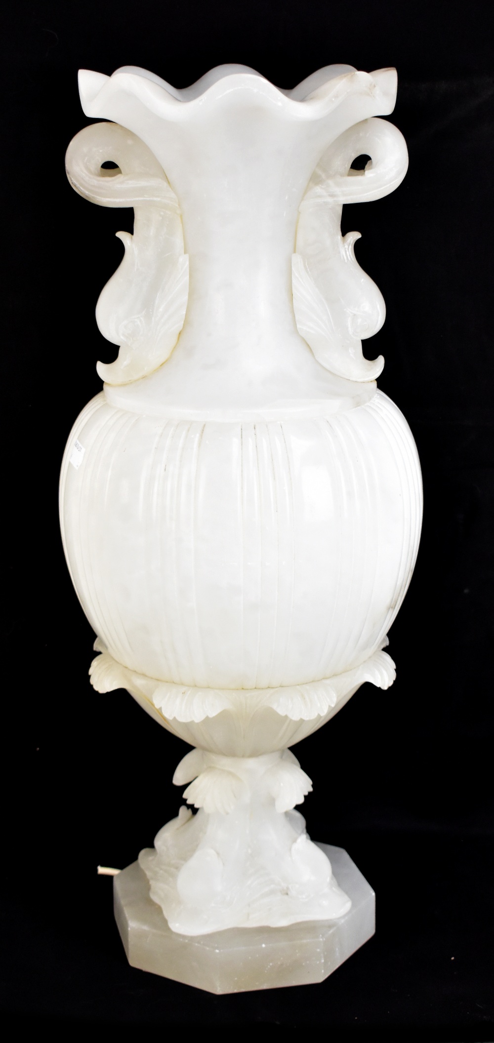 A large alabaster table lamp modelled as a Classical style urn with crimped rim and grotesque