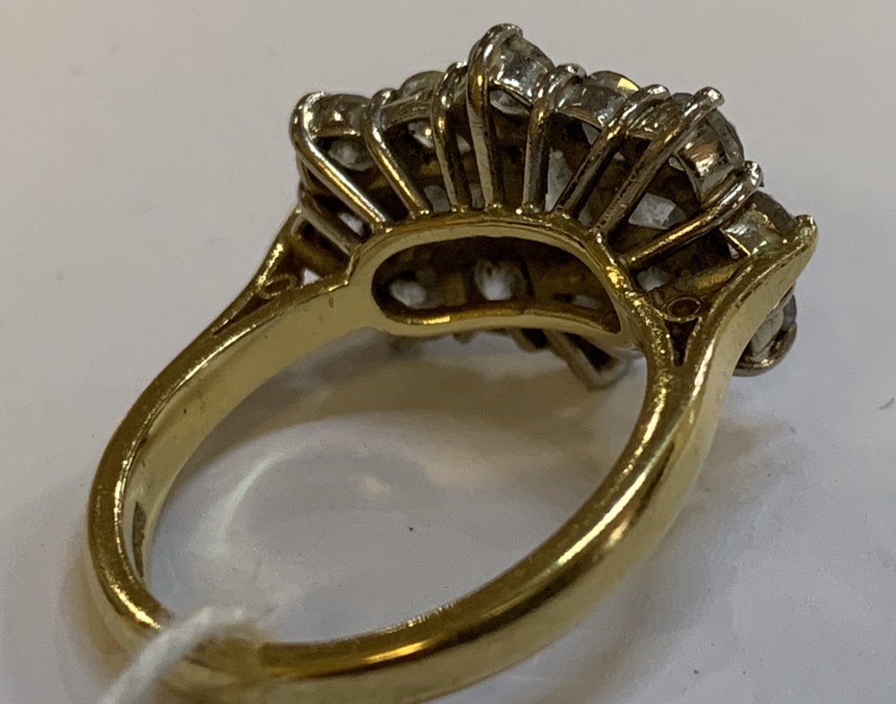 An 18ct yellow gold and diamond cluster ring, centred with three baguette cut stones within a border - Image 3 of 4