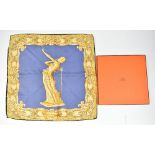 HERMÉS; a gold and blue silk handkerchief entitled 'La Femme en Flammes', with original Hermés Paris